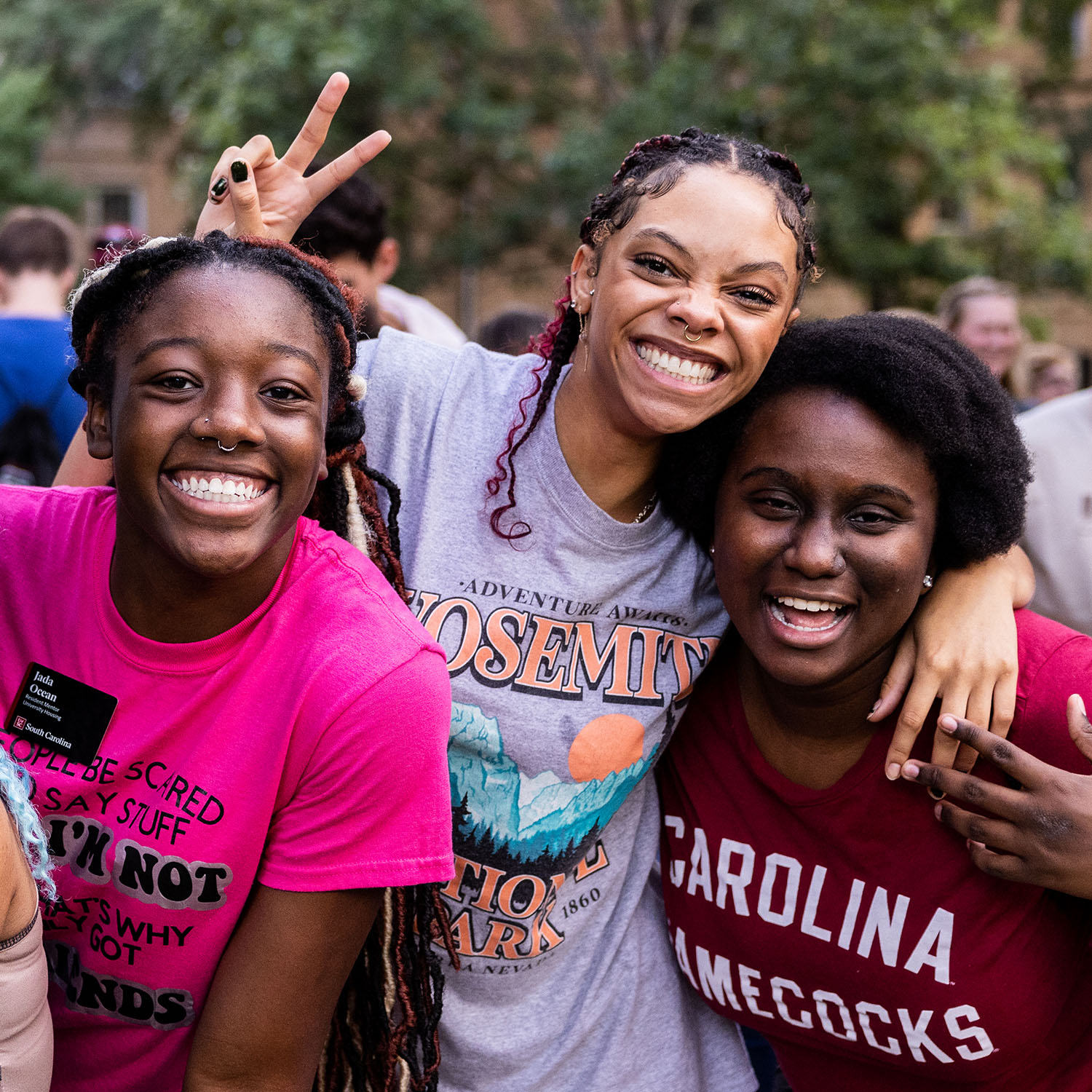 Spirited students raise a peace sign.