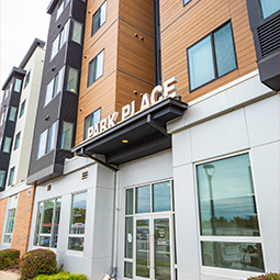 Park Place residence hall is highlighted with night street lighting and apartments rooms lit up.