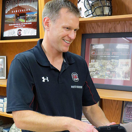 Jason Stacy works with a patient in his office