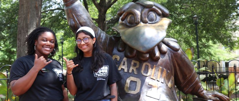 Peer Leader giving a "spurs up" and holding a name tag that says "This could be you!"