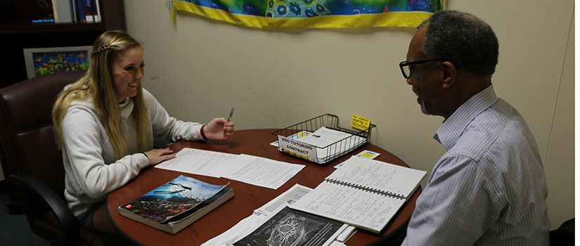 A tutor in the Academic Success Center helping a student