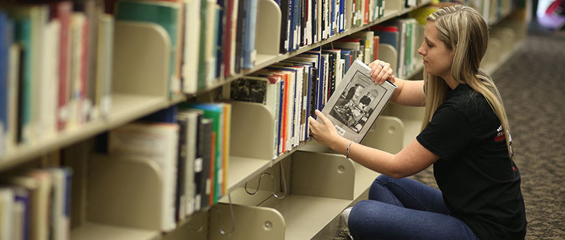 Student browsing books in the library