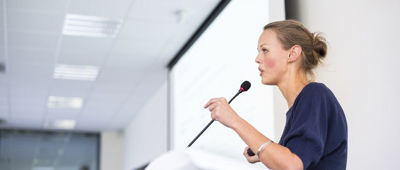 Woman gives a presentation to a crowd