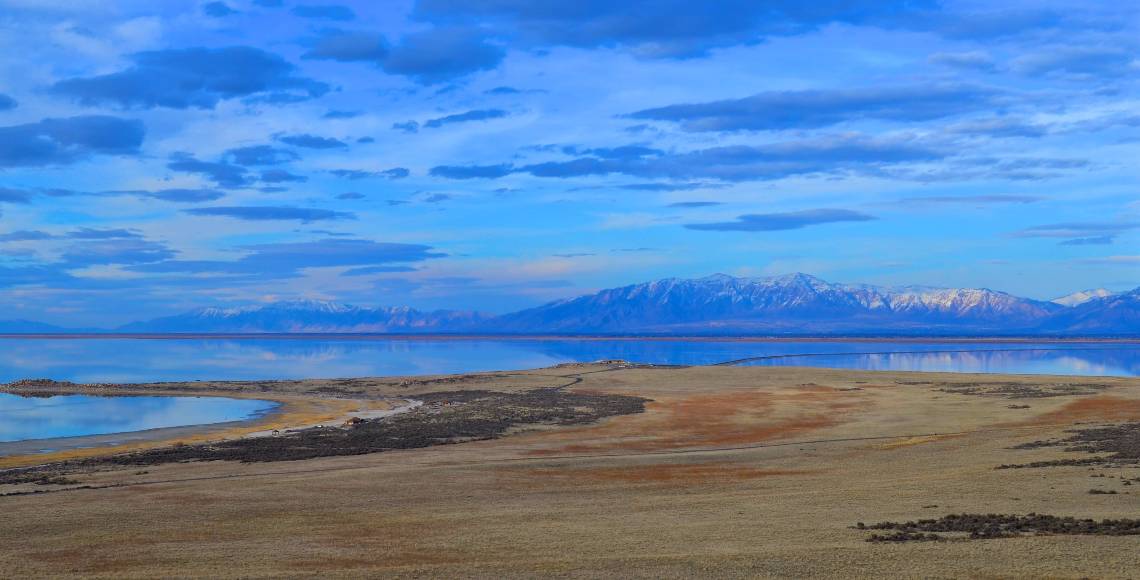 sand water sky and mountains