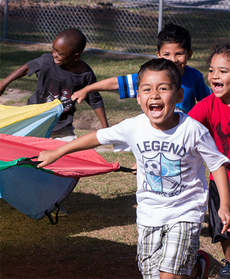 children playing with parachute