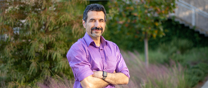 Pooyan Jamshidi stands in the Storey Innovation Center's courtyard.