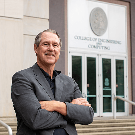 Dr. Sutton in front of building