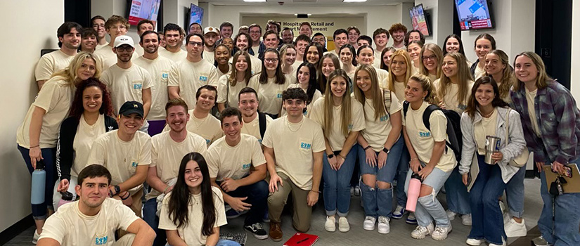 Members of Sigma Psi Mu, a co-ed business fraternity for sport and entertainment management majors, pose for a photo together.