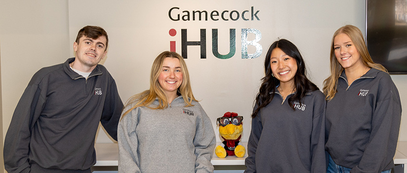 Four Department of Retailing students pose for a photo at the Gamecock iHub