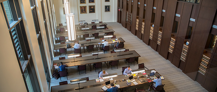 overhead shot looking down at students studying in the law school reading room.