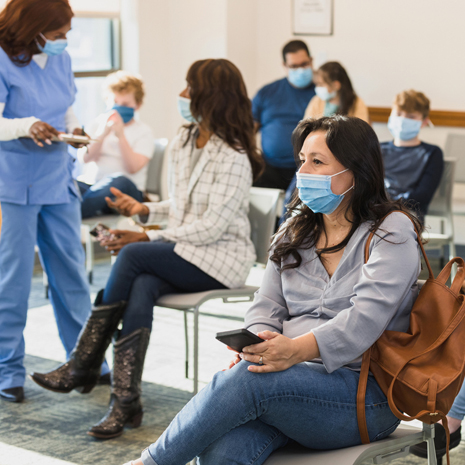 image of diverse group of people waiting in an emergency room