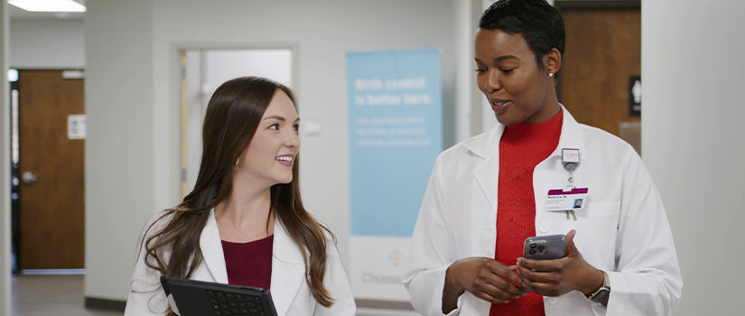 Two pharmacists looking at a file