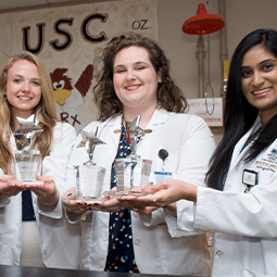 Group of students holding trophies