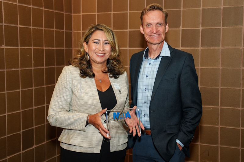 Toni Torres-McGehee (left) accepts the Journal of Athletic Training award on behalf of her co-authors.