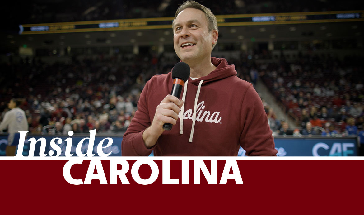 graphic that has a frame with the words Inside Carolina over an image of a man holding a microphone in an arena