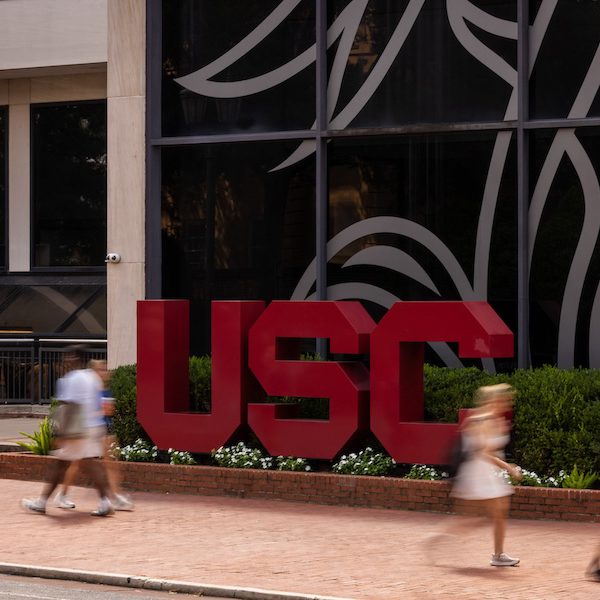 garnet block USC letters in front of Russell House