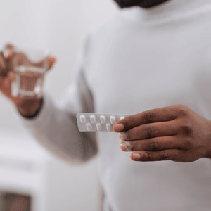 Photo of a blister pack of medicine being held an adult man.