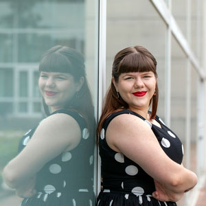 katherine kimbrough stands next to a building 