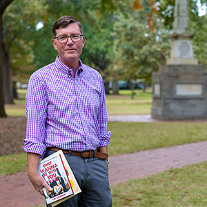 Michael McGandy holds books on the Horseshoe.