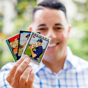 professor Khalid Ballouli shows some of his professional baseball cards