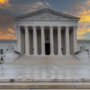 Supreme Court building with an orange sunset