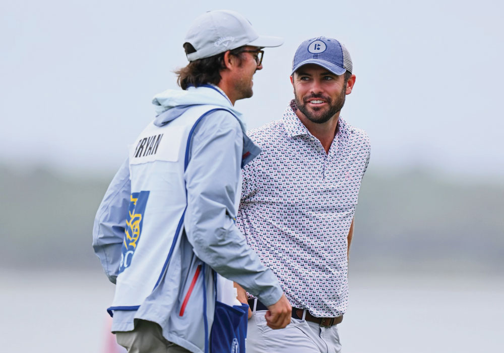 George Bryan IV and Wesley Bryan conversing on a golf course.