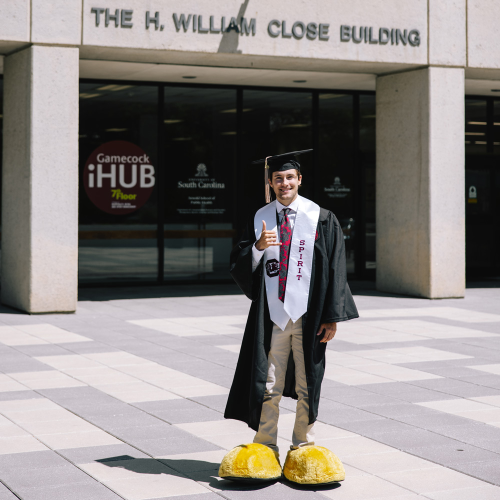 John stands in front of the Close Hipp Building which is home to the College of Hospitality, Retail and Sport Management.